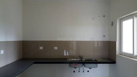 Kitchen featuring a double sink, window, and durable countertop with ample workspace. in TVS Emerald LightHouse