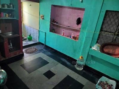 The kitchen has teal walls and a tiled floor The kitchen has teal walls and a tiled floor